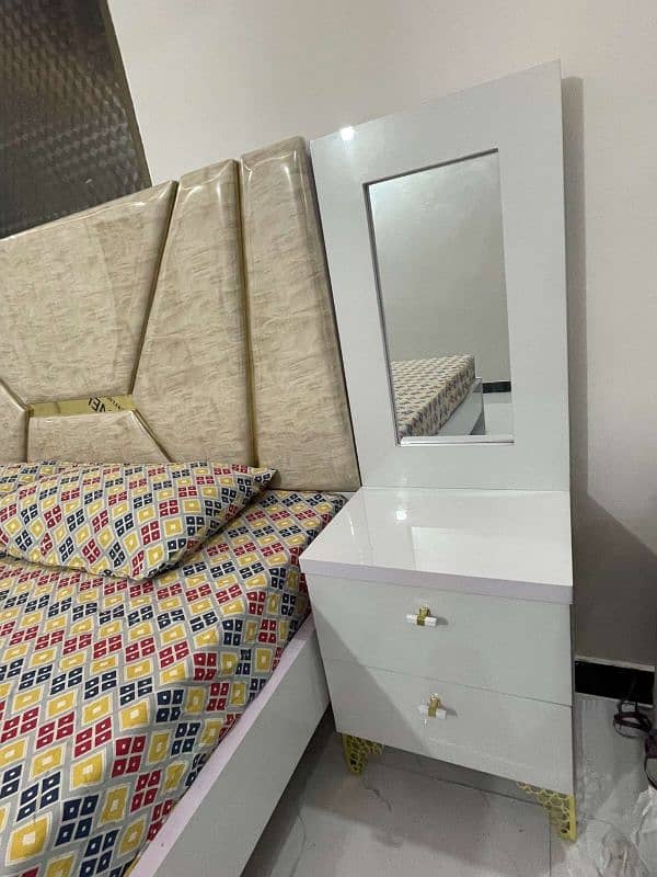 White bed set with side tables and vanity. 1