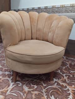 Two seater crowned shape brown colour sofa with free center table