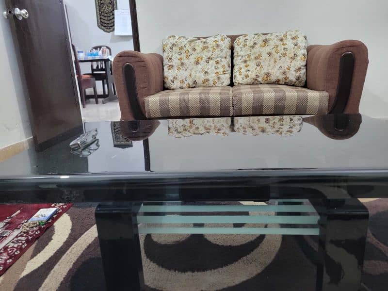 Spacious 7-seater sofa along with glass top center table. 2