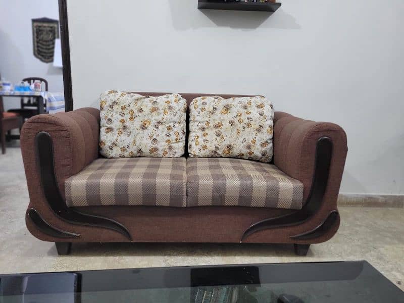 Spacious 7-seater sofa along with glass top center table. 3