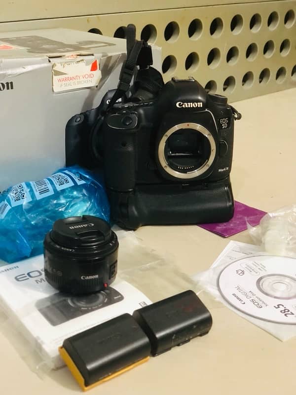 canon 5D mark 3 with box & original Gripe charger &3 betrys 3