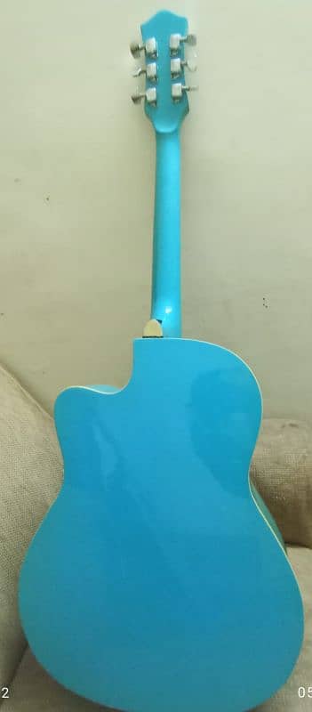 A light blue full size acoustic guitar with all accessories 2