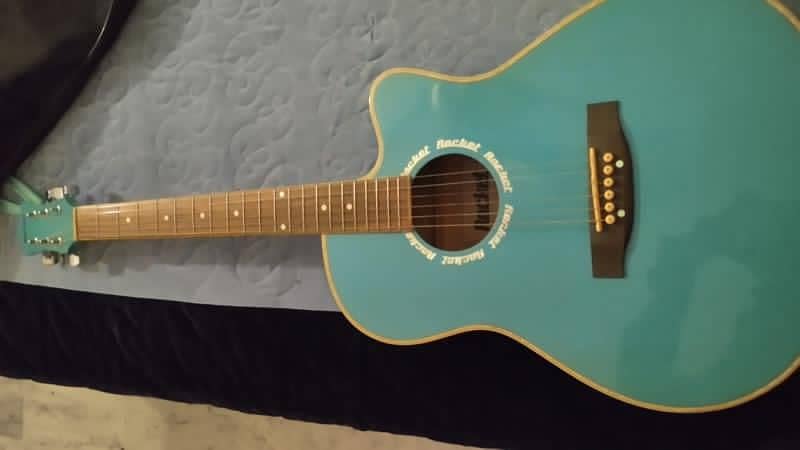 A light blue full size acoustic guitar with all accessories 0