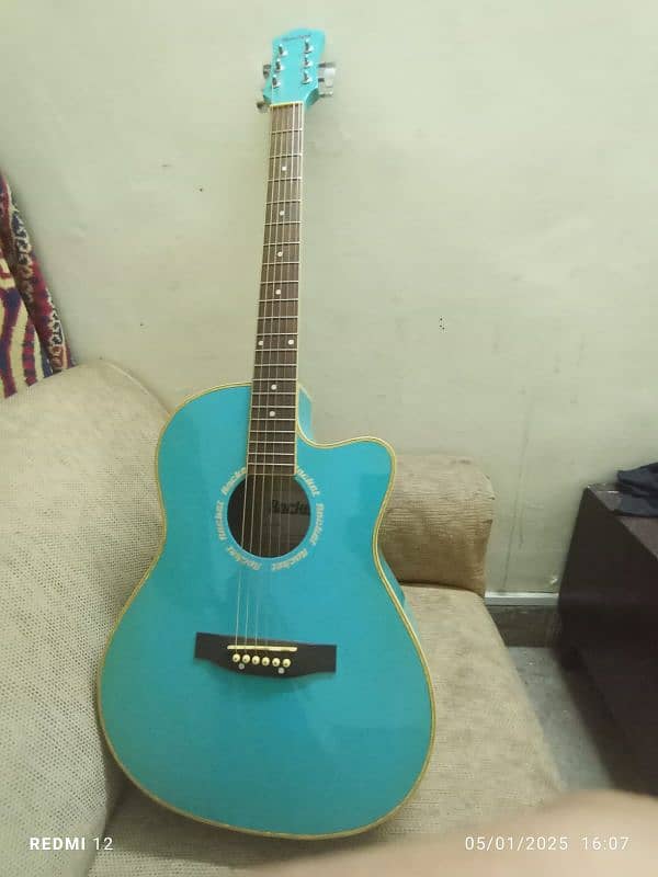 A light blue full size acoustic guitar with all accessories 1