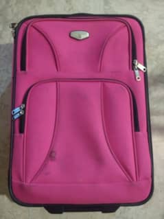 pink color small luggage bag with backpack