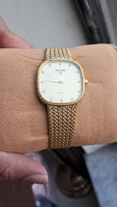 rado movado nivada golden watch with stones