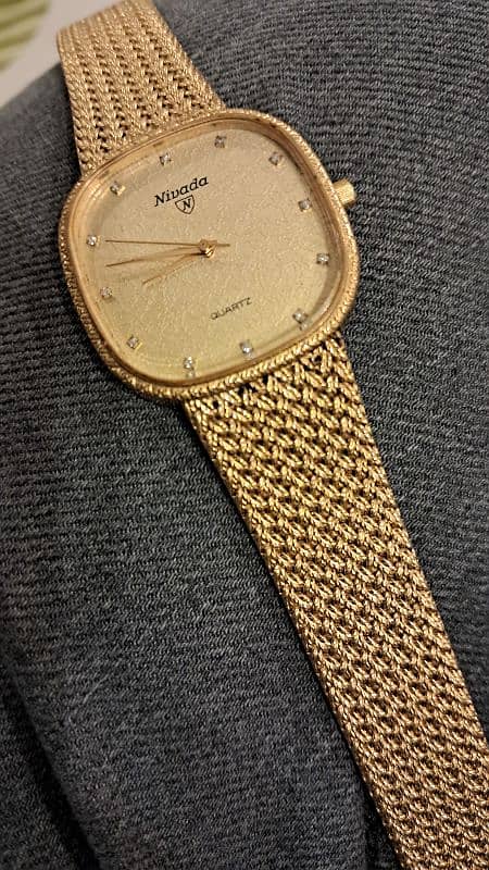 rado movado nivada golden watch with stones 3