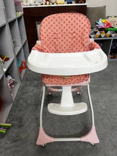 Lightweight pink high chair in excellent, like-new condition