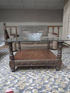 wooden table with glass top 9 /10condition with carving on four sides