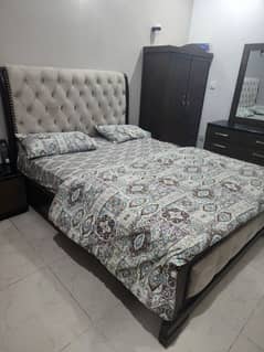 Queen Bed with Dresser and Two Side Tables from Address Furniture.