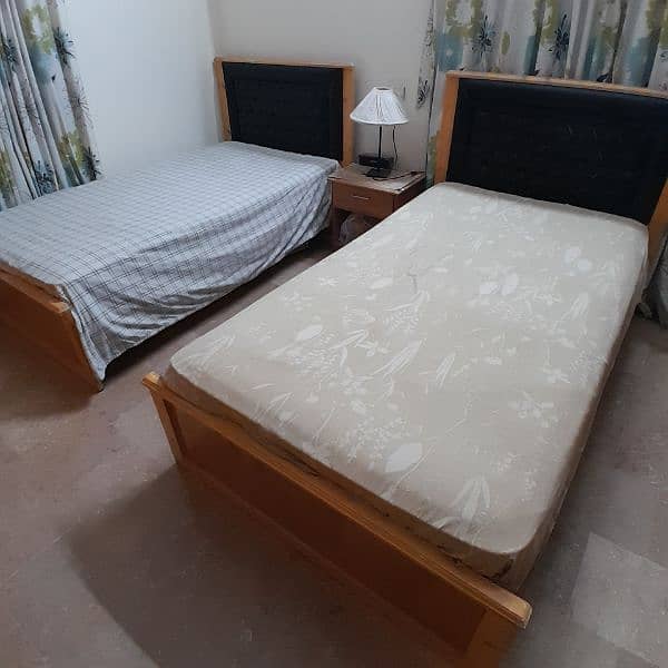 2 single wooden beds with spring mattresses 1