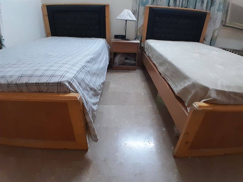 2 single wooden beds with spring mattresses 2