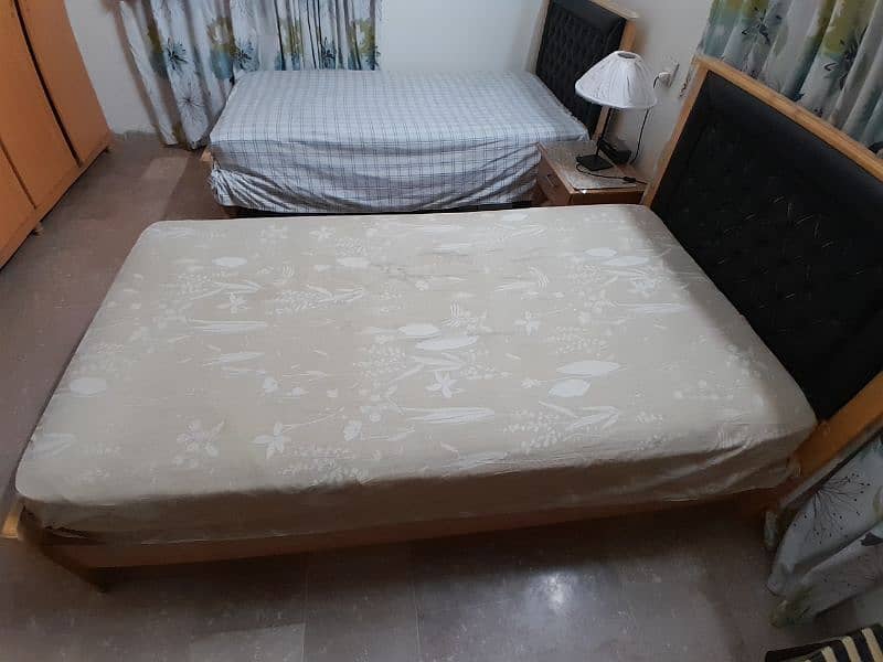 2 single wooden beds with spring mattresses 3