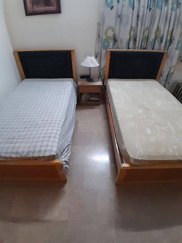 2 single wooden beds with spring mattresses 4