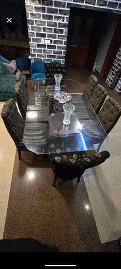 glass dining table with 8 chairs.