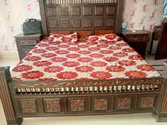 used wooden bed without mattress and side tables