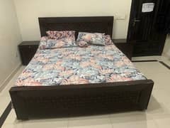 king size bed with side table and dressing table