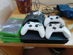 xbox one x 1Tb with 4 controllers and 5 Games