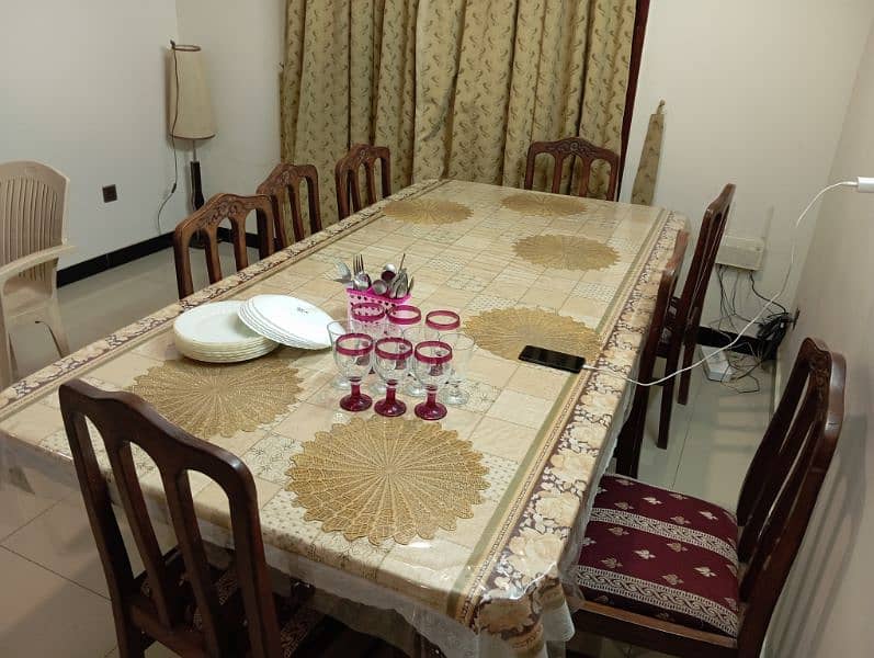 well maintained dinning table with set of eight chairs 1