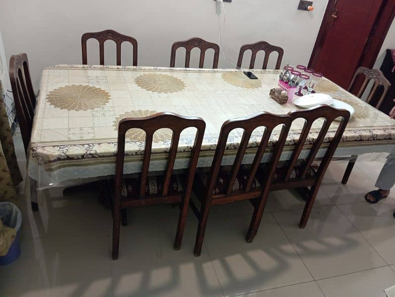 well maintained dinning table with set of eight chairs 2