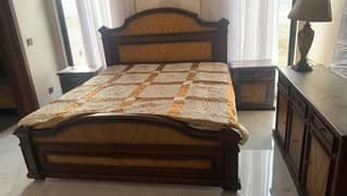 wooden bed with two side tables, mattress and dressing table