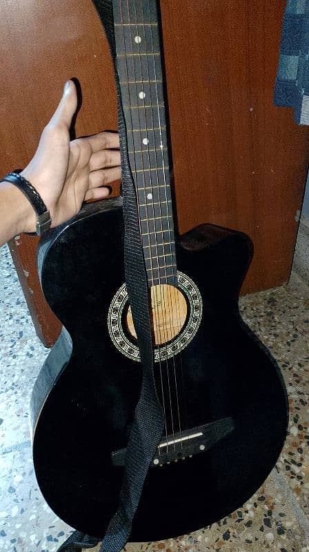 Black guitar good quality, open from down side and has 5 strings 4