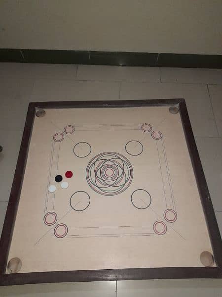 carrom with its all black,white and a red coin + stricker 2