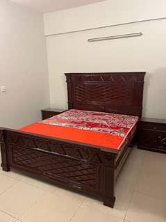 Wooden bed with side tables, dresser and chairs