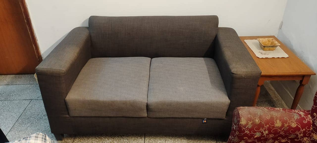 2 seater sofa (2.5ft 10inch x 5ft 3inch). Cover included. Good qlty. 2