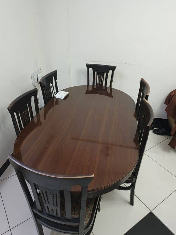 6 seater wooden dinning table with glass on top 1