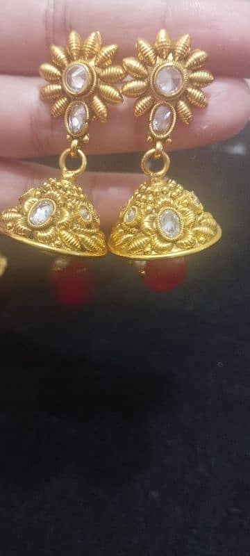 A golden red set and green earrings with bindiya 2