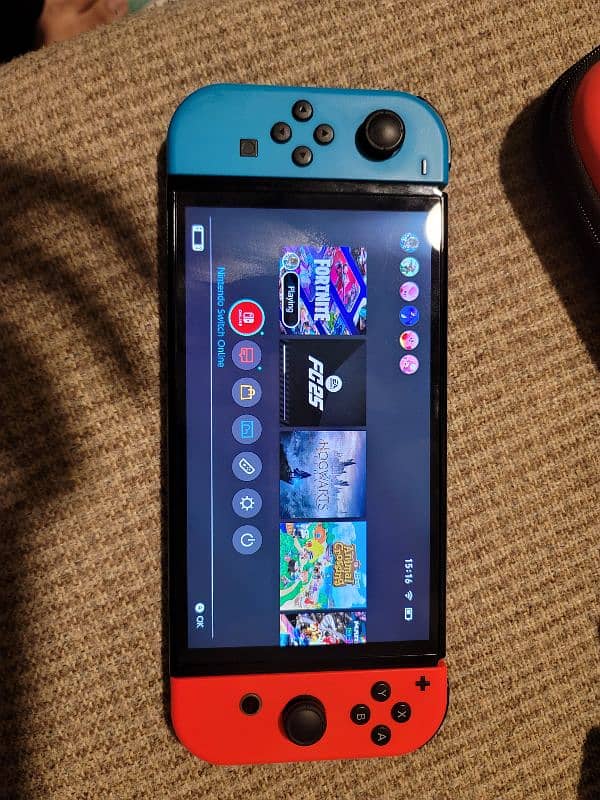 Nintendo Switch Oled ( with original case and joy cons grip) 0