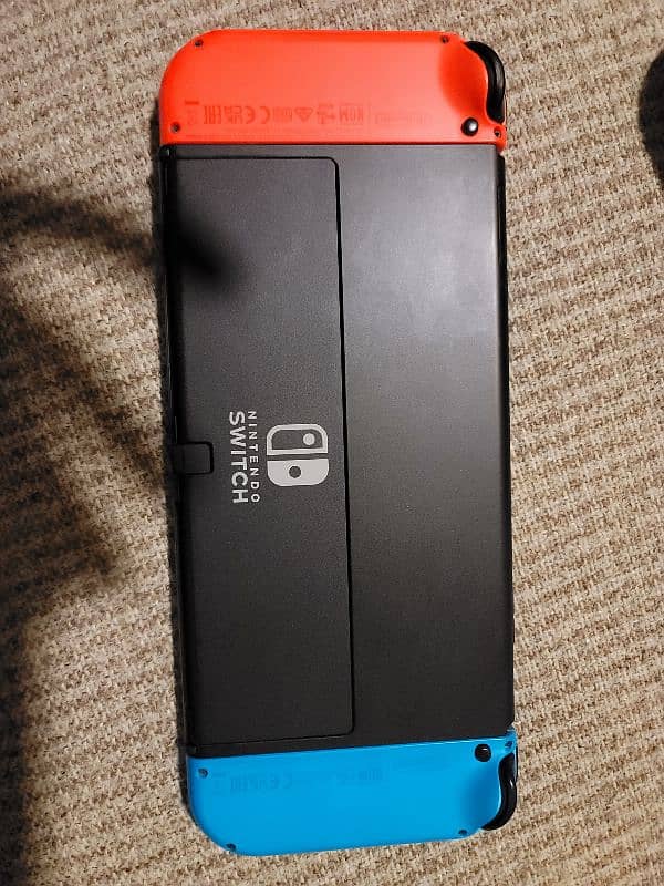 Nintendo Switch Oled ( with original case and joy cons grip) 1