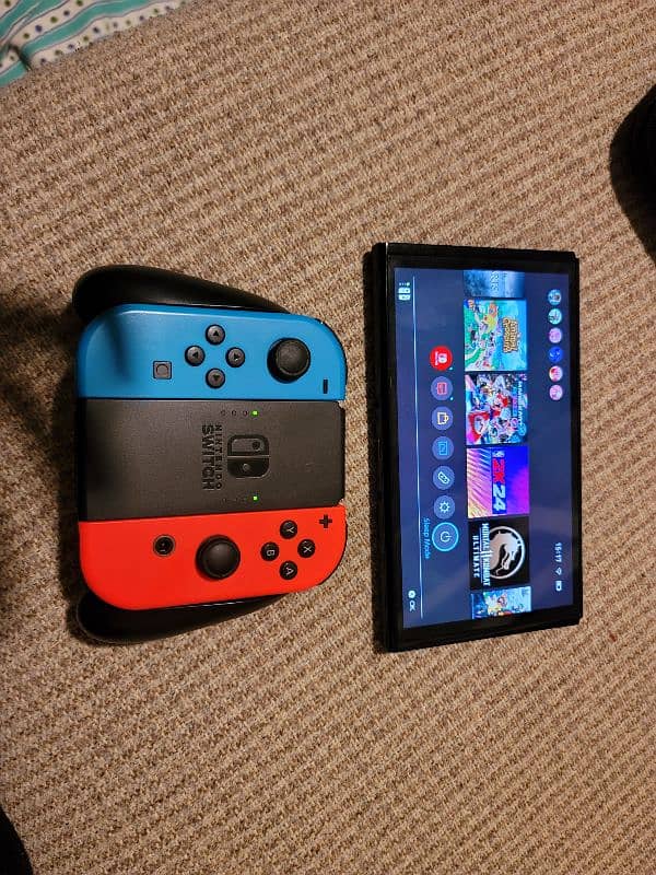 Nintendo Switch Oled ( with original case and joy cons grip) 4