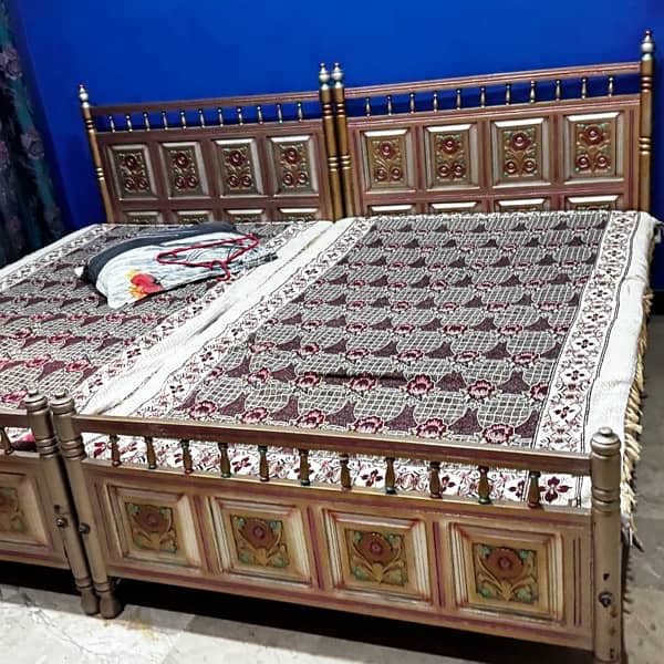 Set of 2 single wooden beds 18000 each 0