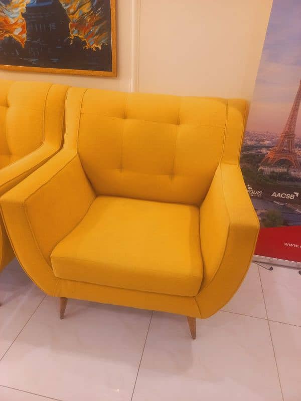 2 yellow colour sofa chair 1