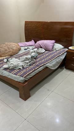 Wooden bed with sidetables and mattress