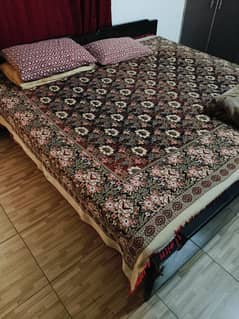 2 wooded beds with mattress with cover