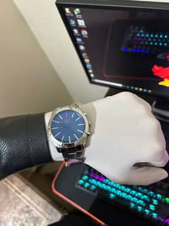 silver watch with blue dial with stainless steel straps