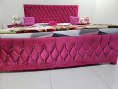 Pink double bed with side tables without mattress