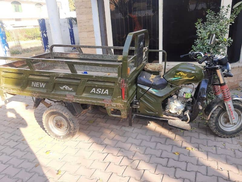 The lorder rickshaw in green colour location:khan house,6 Road A block 2