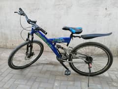 mountain bicycle with 1 disk brake , 1 suspension and gears