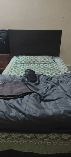 Single bed with mattress and side table