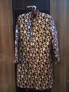 maroon sharwani with gold tilla work