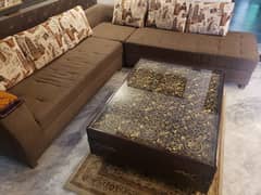 L shapped 7 seater sofa with a beautiful antique table