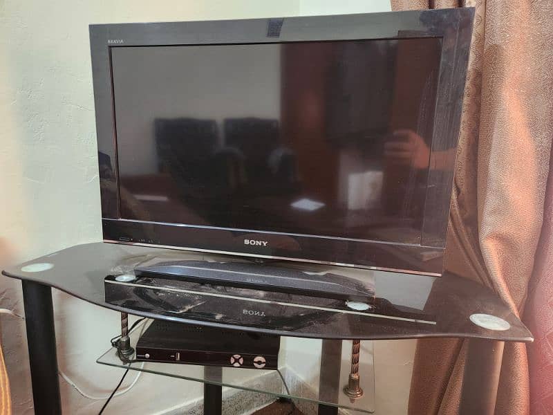 Sony TV with Dish TV Receiver and table. 0