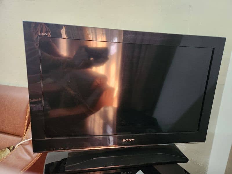 Sony TV with Dish TV Receiver and table. 1