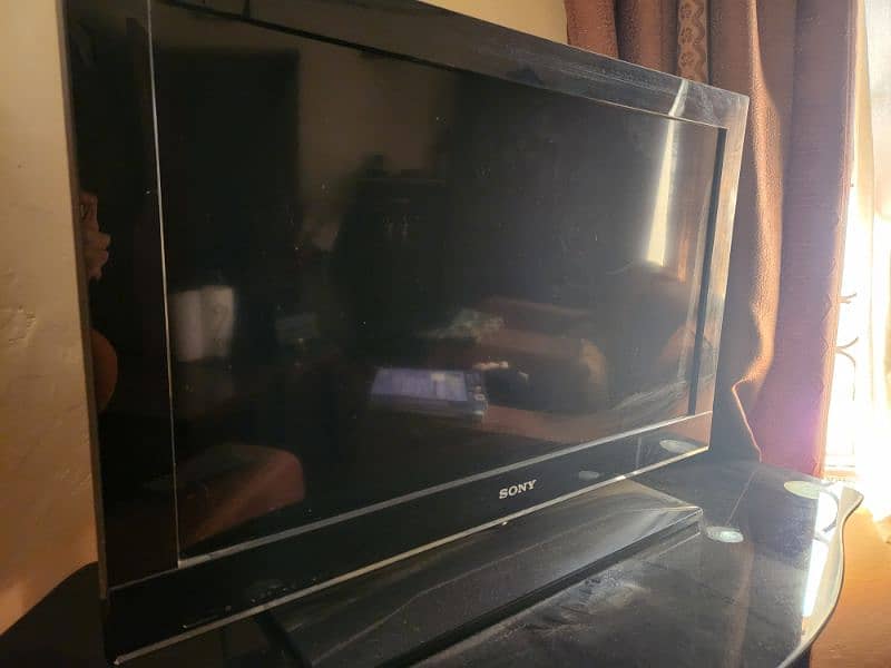 Sony TV with Dish TV Receiver and table. 2