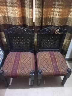 2 carved wooden chairs