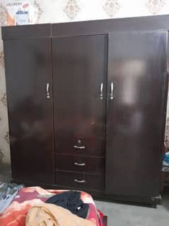 a big wardrobe with three doors three draws